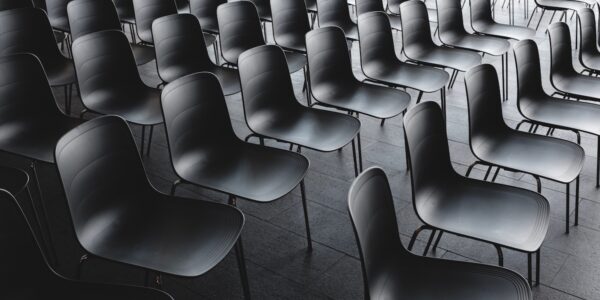Rows of black chairs in a meeting room